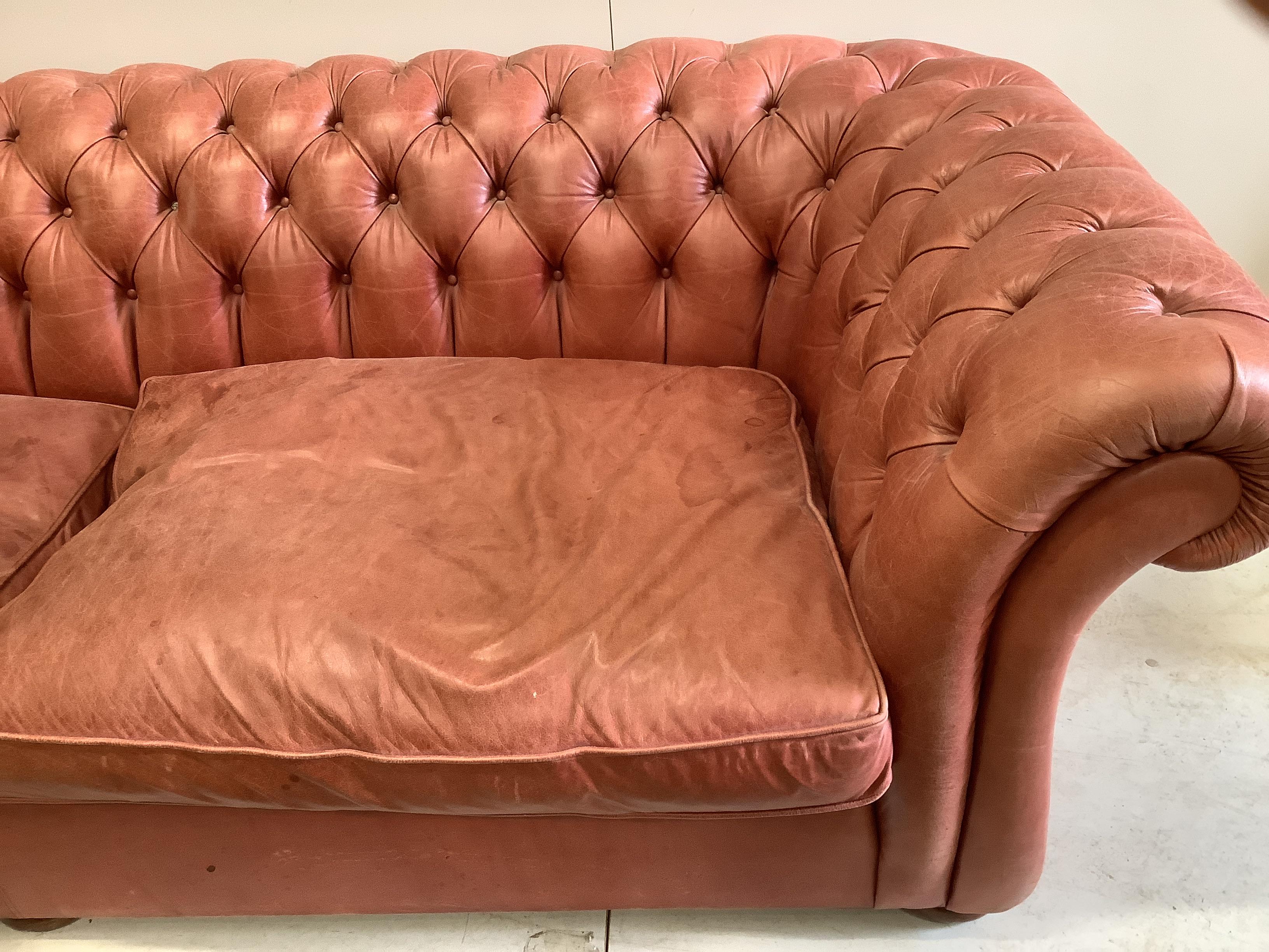A large Victorian style buttoned back pale red leather Chesterfield settee, width 270cm, depth 104cm, height 76cm